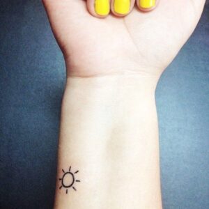 sun tattoo on wrist