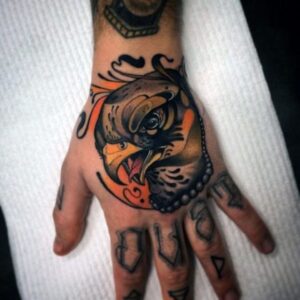 colorful falcon tattoo on hand