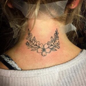 Pretty flower back of neck tattoo