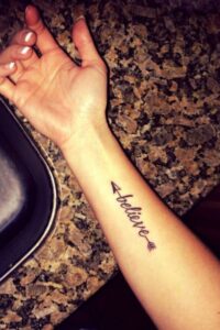Arrow Tattoo With Quote In Middle of Hand