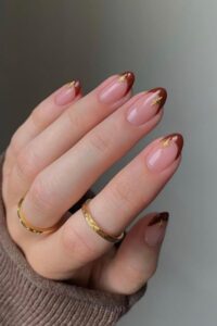 Brown tips nails with golden stars