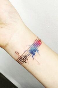 colorful music note tattoo on wrist