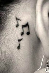 behind the ear music note tattoo