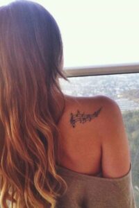 music note tattoo on shoulder