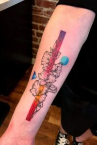 colorful gladiolus tattoo on forearm
