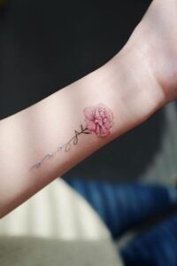 Beautiful Pink Carnation Tattoo with a Word